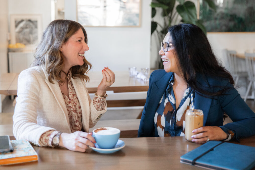 Amy Rogan-Mehta and Gabriela "Gabby" Castañeda, vice president of first-generation and promising futures programs, meet at Bluestone Lane coffee shop in Old Towne Orange.
