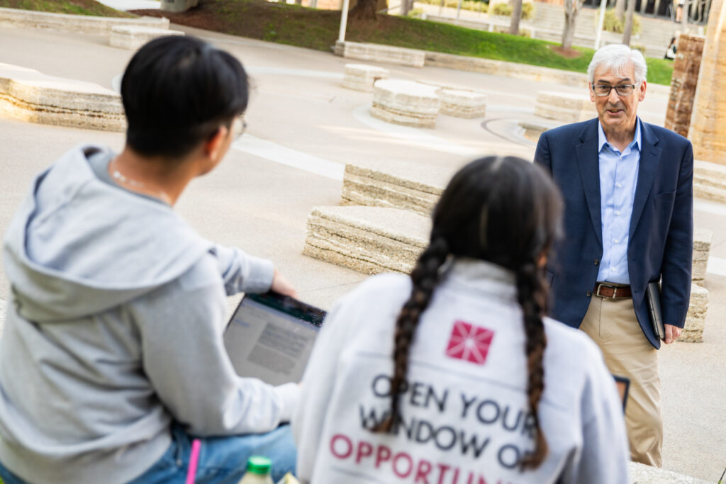Rick Bischoff talks with students at the Orange campus of Chapman University.