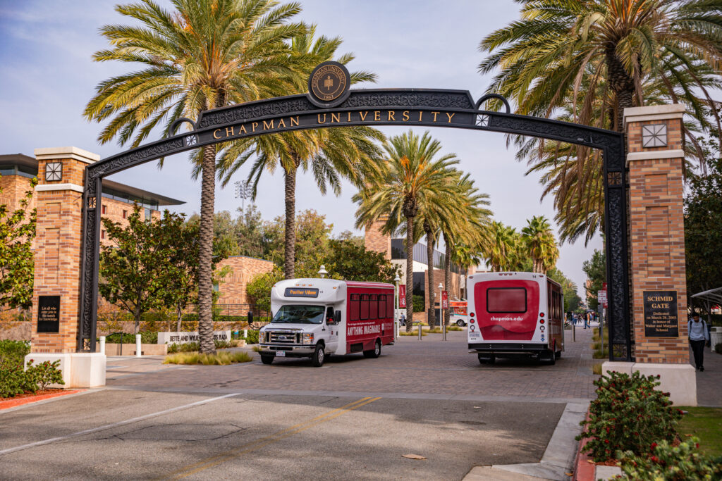 Chapman shuttles pick up students at Schmid Gate
